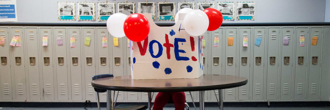 student votes in mock election booth